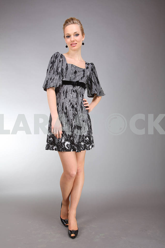 Beautiful young woman in light dress with gray background — Image 7260