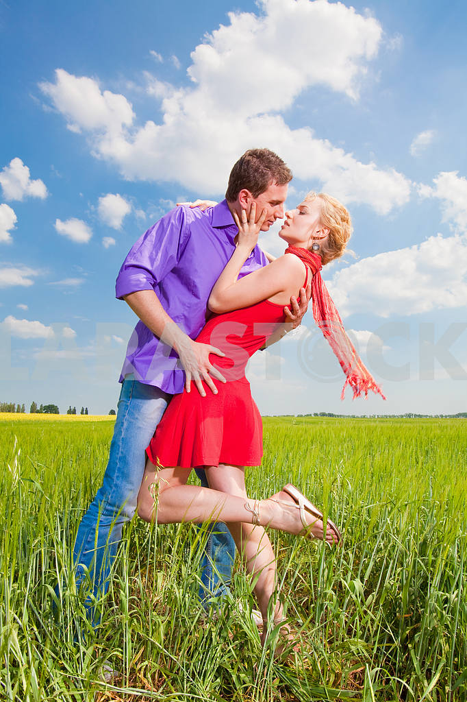 Beautiful young couple kissing on the grass — Image 8263