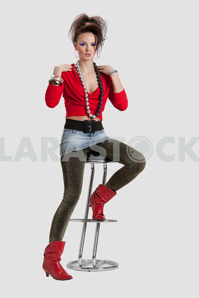 Picture of a young playful lady on a high chair — Image 64446