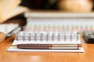 Stack of hardback books on wooden table. Back to school. Copy space. Top view