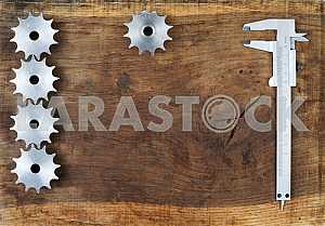 Different construction tools on a wooden background - screwdriver, caliper.