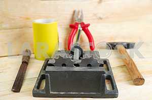 Different construction tools on a wooden background - screwdriver, caliper.