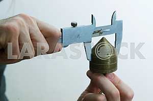 Different construction tools on a wooden background - screwdriver, caliper.