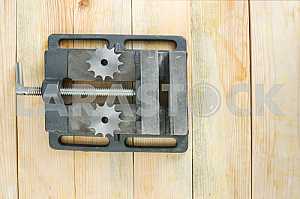 Different construction tools on a wooden background - screwdriver, caliper.