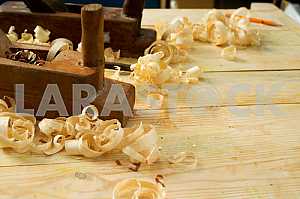 Carpenter tools on wooden table with sawdust. Circular Saw.