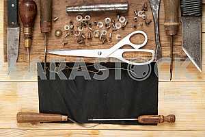 Carpenter tools on wooden table with sawdust. Circular Saw.