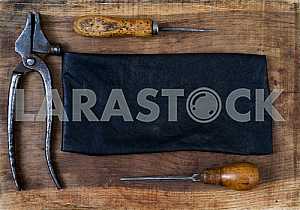 Different construction tools on a wooden background - screwdriver, caliper.