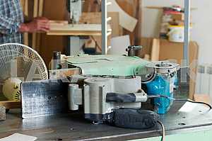 Carpenter tools on wooden table with sawdust. Circular Saw. Carpenter workplace top view