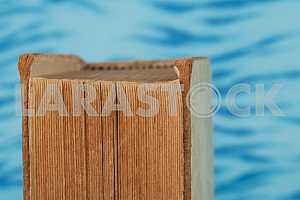 Old and used hardback books or text books on wooden table. Books and reading are essential for self improvement, gaining knowledge and success in our careers, business and personal lives. Copy space