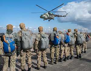 Marines prepare to jump from a helicopter