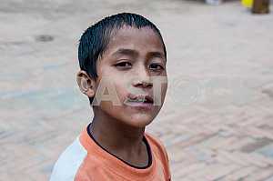 Curious Nepali boy looks at tourists.