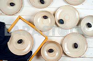 Blank white dish on a wood background.