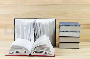 Stack of hardback books on wooden table. Back to school. Copy space
