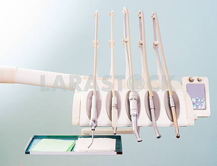 Stomatological instrument in the dentists clinic. Operation, tooth replacement.