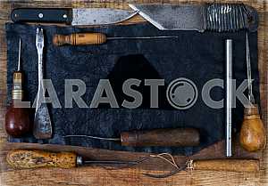 Different construction tools on a wooden background - screwdriver, caliper.