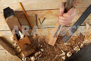 Carpenter tools on wooden table with sawdust. Circular Saw.
