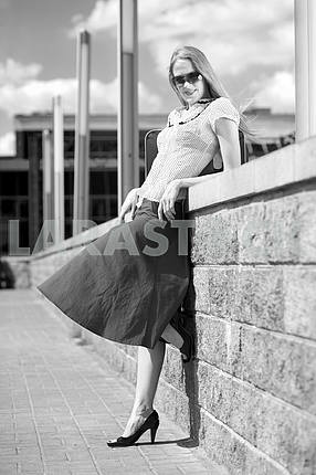 Black & White portrait smiling sexy blonde girl wearing skirt. I