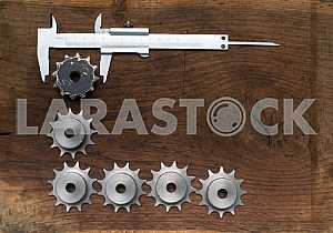 Different construction tools on a wooden background - screwdriver, caliper.