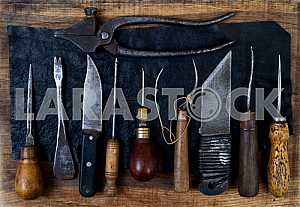Different construction tools on a wooden background - screwdriver, caliper.