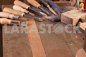 Carpenter tools on wooden table with sawdust. Circular Saw. Carpenter workplace top view