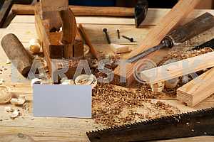 Carpenter tools on wooden table with sawdust. Circular Saw.