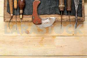 Carpenter tools on wooden table with sawdust. Circular Saw.