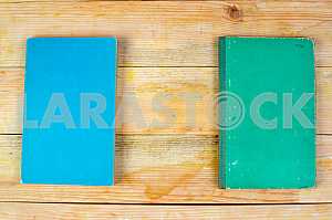 Open book, stack of hardback books on wooden table. Back to school. Copy space