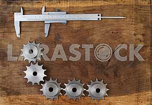 Different construction tools on a wooden background - screwdriver, caliper.