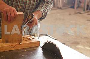 Carpenter tools on wooden table with sawdust. Circular Saw. Carpenter workplace top view