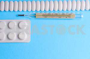 Many pills and tablets isolated on light blue background