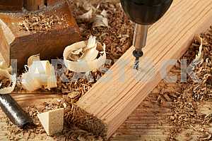 Carpenter tools on wooden table with sawdust. Circular Saw.