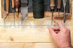 Carpenter tools on wooden table with sawdust. Circular Saw.