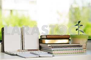 Stack of hardback books on wooden table. Back to school. Copy space. Top view