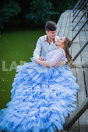 A love story couple, in love, together in the forrest park, on the wooden bridge, girl in a beautiful violet dress, sunny evening, summer, green water on the background
