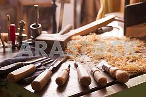 Carpenter tools on wooden table with sawdust. Circular Saw. Carpenter workplace top view