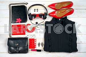 Women clothing set and accessories on white wooden background.