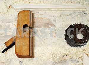 Different construction tools on a wooden background - screwdriver, caliper.