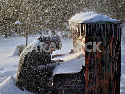 Музыкант, засыпанный снегом, сидит за роялем.
