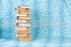 Old and used hardback books or text books on wooden table. Books and reading are essential for self improvement, gaining knowledge and success in our careers, business and personal lives. Copy space