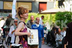 The girl with an accordion on the streets of Antwerp