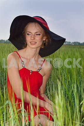 Portrait of a beautiful young woman in a white hat