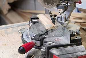 Different construction tools on a wooden background - screwdriver, caliper.