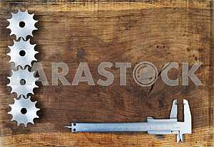 Different construction tools on a wooden background - screwdriver, caliper.