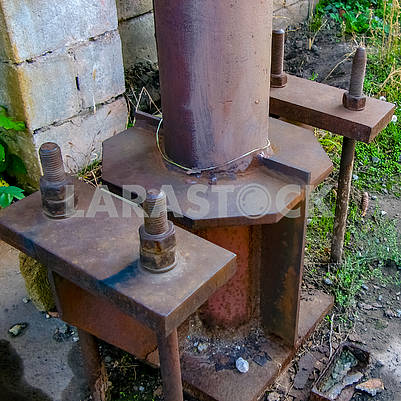 Rusty metal support with bolts and nuts
