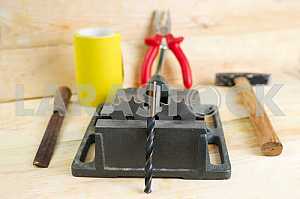 Different construction tools on a wooden background - screwdriver, caliper.