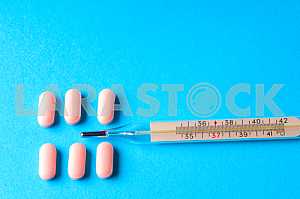 Many pills and tablets isolated on light blue background