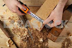 Carpenter tools on wooden table with sawdust. Circular Saw.