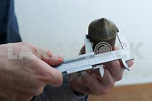 Different construction tools on a wooden background - screwdriver, caliper.