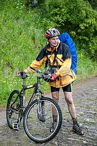 Tourists with backpacks on the bike in the Carpathian Mountains