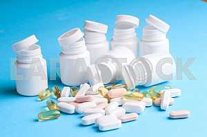 Many pills and tablets isolated on light blue background